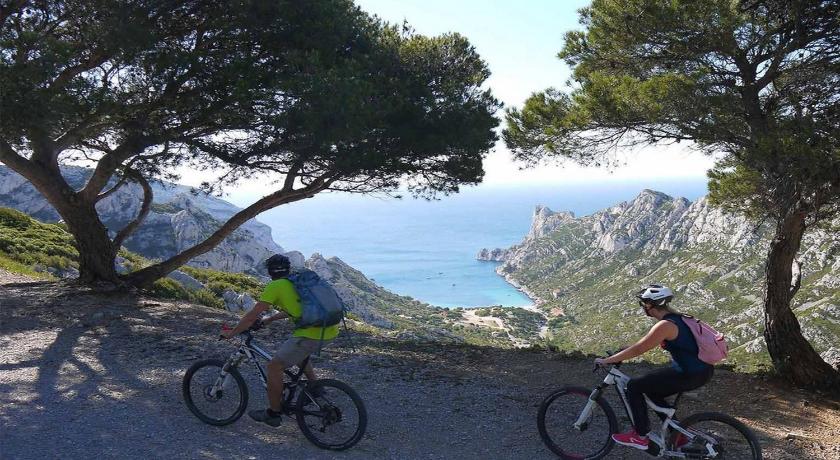 a person riding a bike on top of a mountain, Residence La Canebiere in Marseille