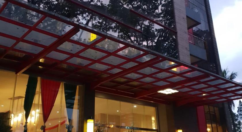 a building with a red umbrella on top of it, Scarlet Dago Hotel in Bandung