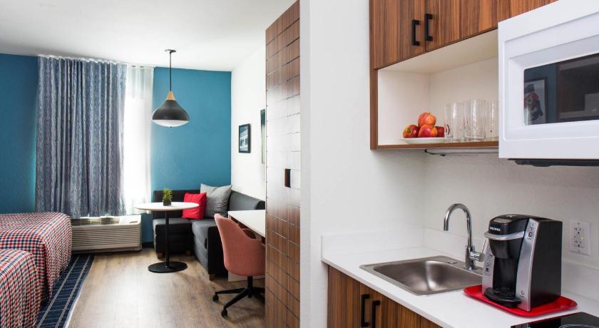 a kitchen with a sink and a microwave, Uptown Suites Extended Stay Denver CO -Westminster in Westminster (CO)