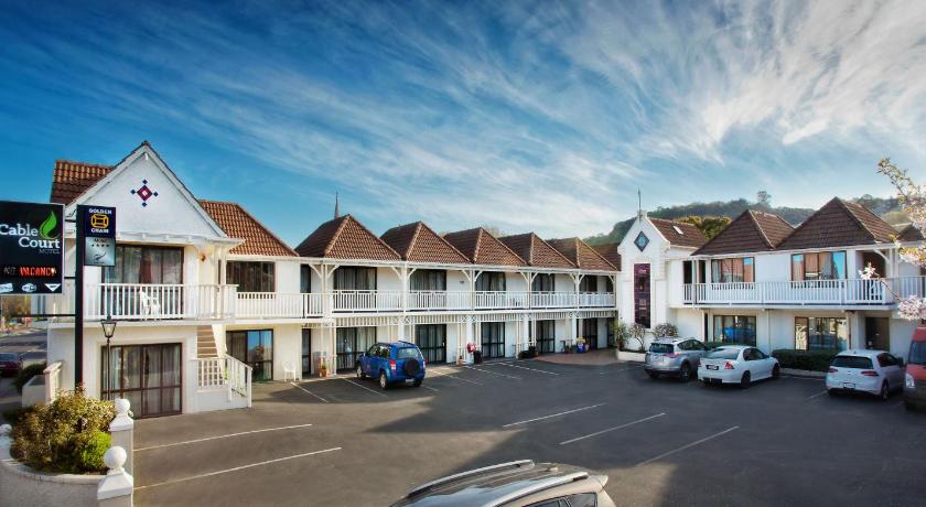 a street scene with cars parked in front of a building, Cable Court Motel in Dunedin