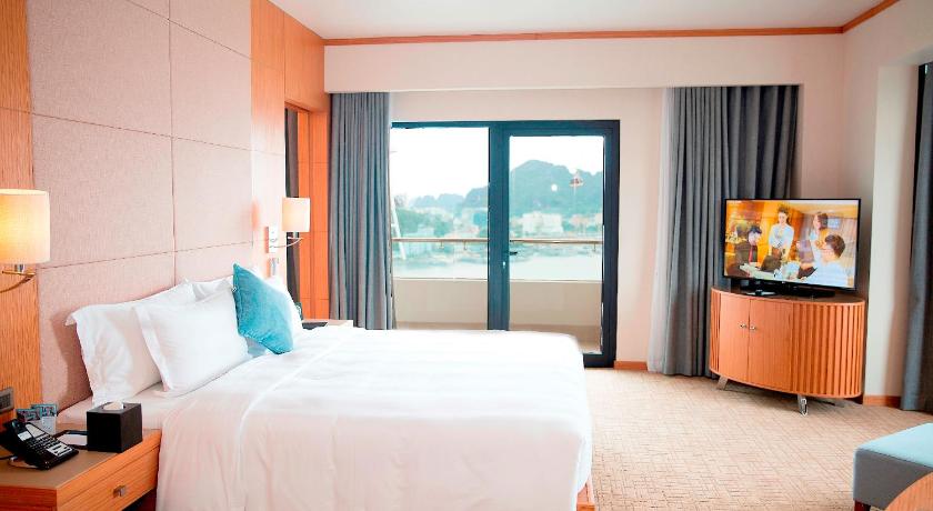 a hotel room with a bed and a television, Wyndham Legend Halong Hotel in Hạ Long