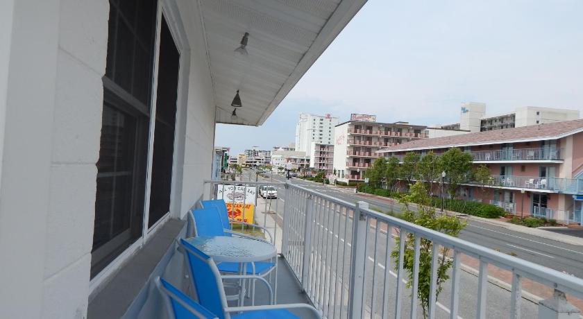 a row of blue chairs sitting on top of a balcony, Sun 'n Fun Motel in Ocean City (MD)