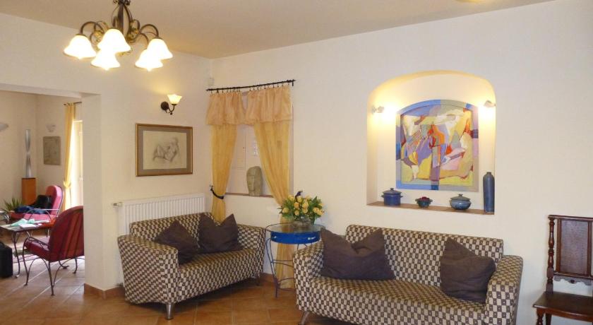 a living room filled with furniture and decor, Albergo Giardino Hotel in Balatongyorok