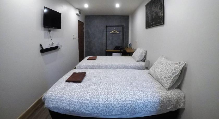 a bedroom with a white bed and white walls, The Ghee House in Chiang Mai