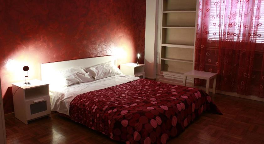 a bedroom with a bed and a lamp, Bologna Center Town in Bologna