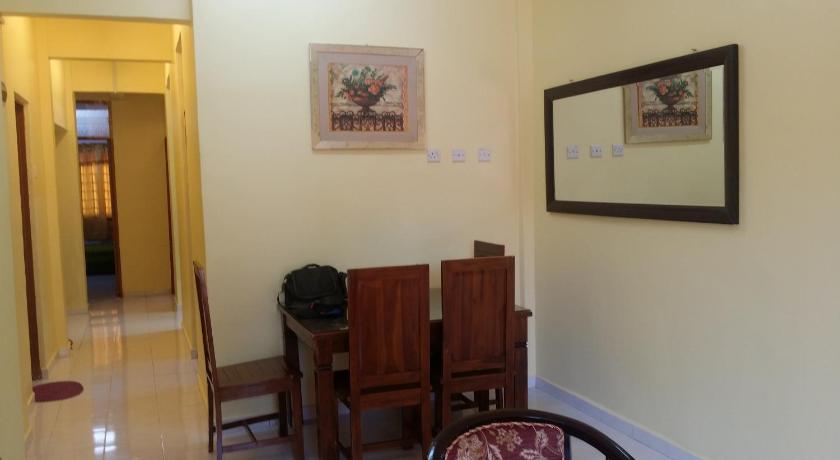 a room with a table, chairs and a mirror, Pangkor Homestay Mewah in Pangkor