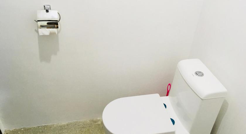 a white toilet sitting next to a white sink, ShareGao in Siargao Island