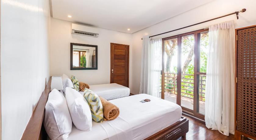 a bedroom with a large bed and a large window, Balay Kogon in Carles