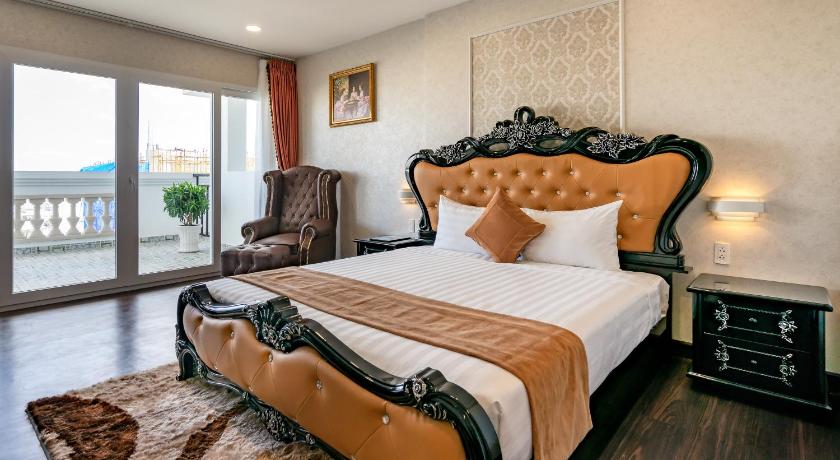 a bedroom with a large bed and a large window, Emerald Central  in Ho Chi Minh City