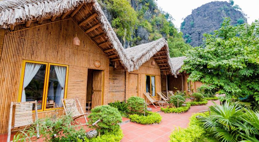 a large building with a large window and trees, Tam Coc Horizon Bungalow in Ninh Bình