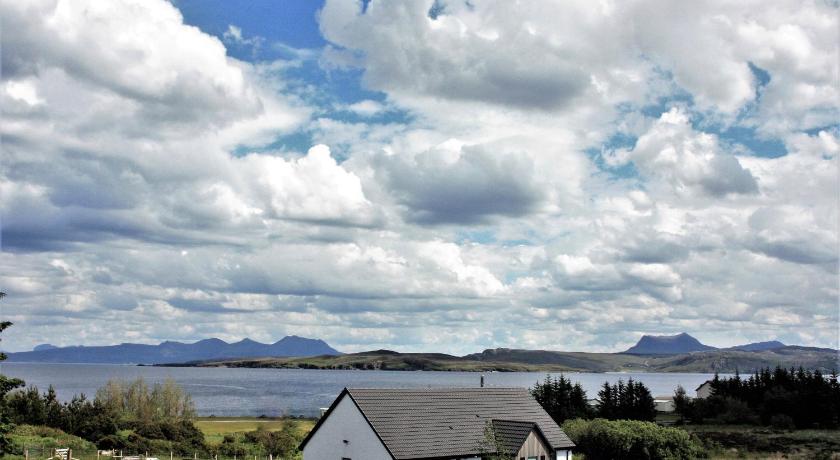a house on a hill overlooking a body of water, An Cois Na Mara Bed & Breakfast in Laide