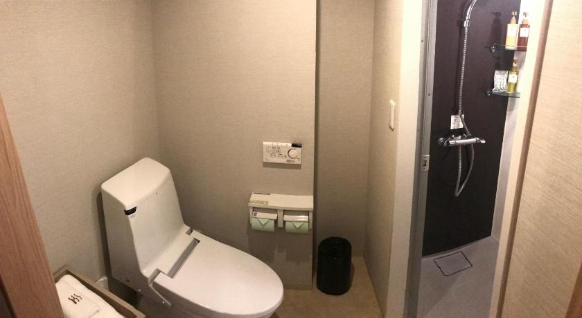 a bathroom with a toilet and a sink, K's Street Hotel Miyazaki in Miyazaki