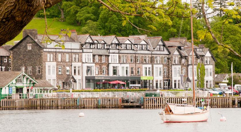 a small boat docked in front of a large building, YHA Ambleside Hostel in Ambleside