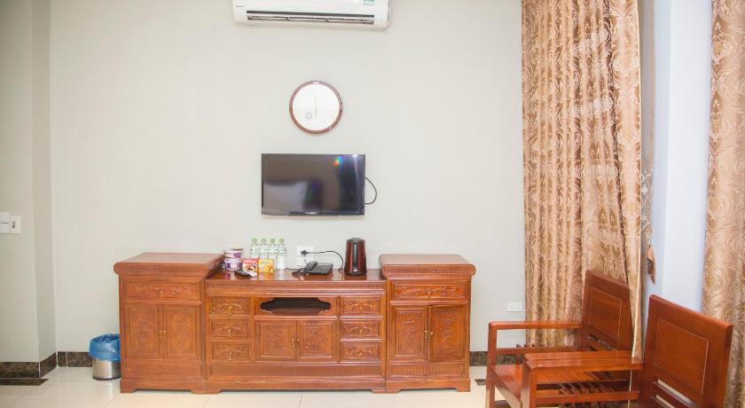 a living room filled with furniture and a tv, Hoang Gia Hotel in Lao Cai City