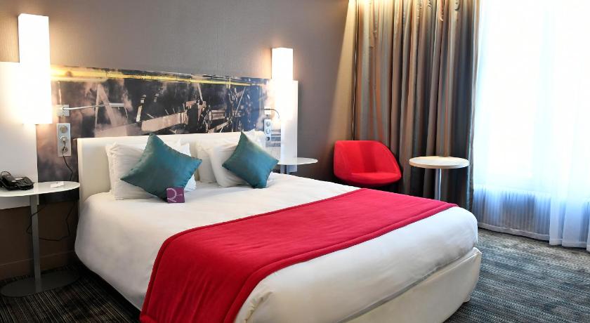 a hotel room with two beds and a large window, Hotel Mercure Paris Gare De L'Est Magenta in Paris