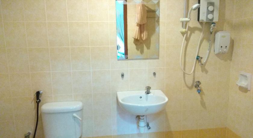 a bathroom with a toilet a sink and a mirror, 1 BEDROOM Suria Service Apartment in Taiping