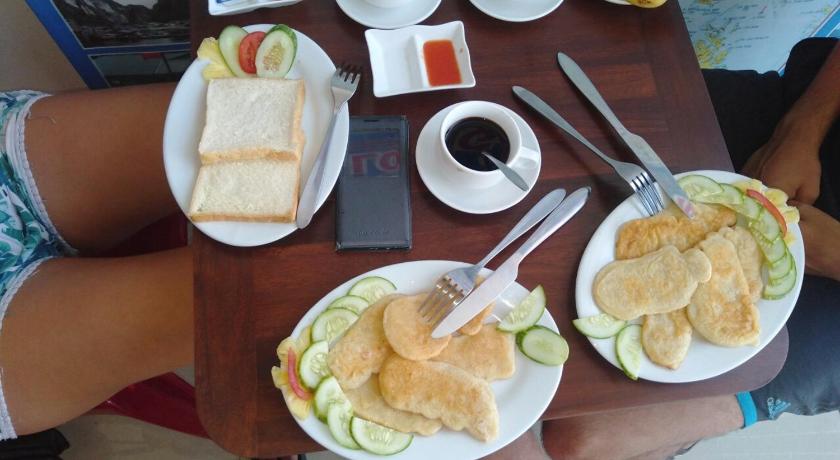 a person sitting at a table with a plate of food, Tom's Family Hotel in Hạ Long