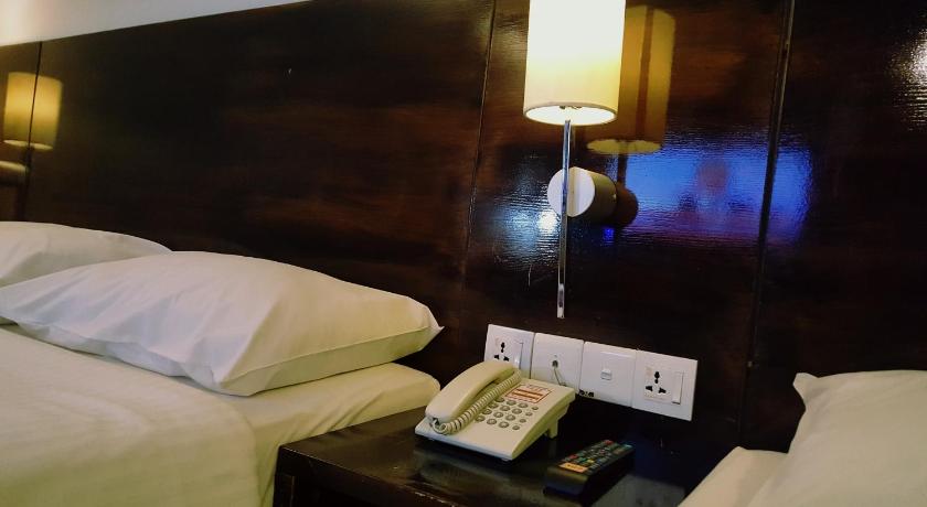 a hotel room with a bed and a television, Super 8 Hotel @ Georgetown in Penang