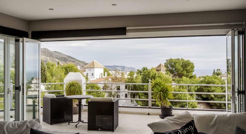a living room filled with furniture and a window, Villa Frigiliana San Rafael in Nerja