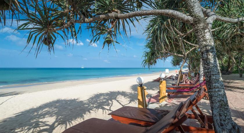 a beach area with chairs, tables and umbrellas, Lanta Miami Resort  (SHA Extra Plus) in Koh Lanta