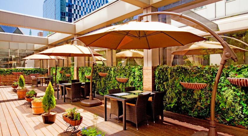 a patio area with umbrellas, tables and chairs, Century Royal Hotel Sapporo in Sapporo