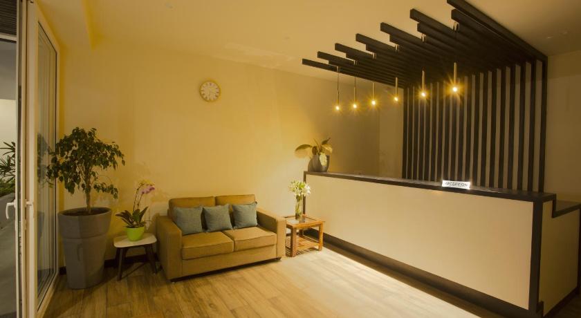 a living room filled with furniture and a couch, The Loft Executive Inn in Shillong