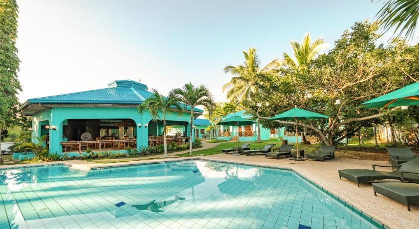 a beach with a pool and a swimming pool, Bohol Sea Resort in Bohol