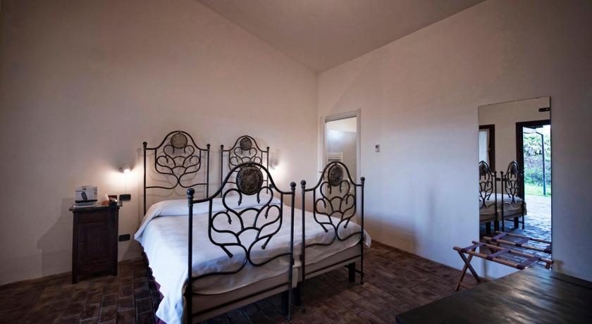 a bedroom with a large bed and a large window, Foro Appio Mansio Hotel in Latina
