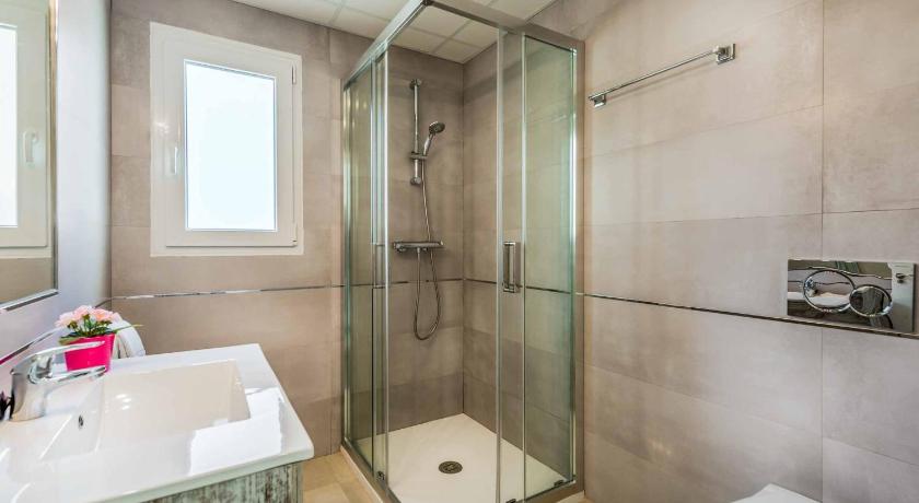 a bathroom with a shower, sink, and toilet, Villa Valeria in Nerja
