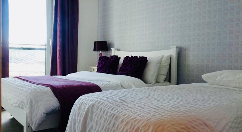 a hotel room with two beds and two lamps, Edinburgh Waterfront Apartments in Edinburgh