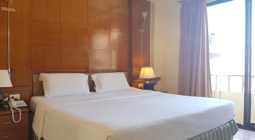 a hotel room with a large bed and a large window, Phi Phi Hotel in Ko Phi Phi