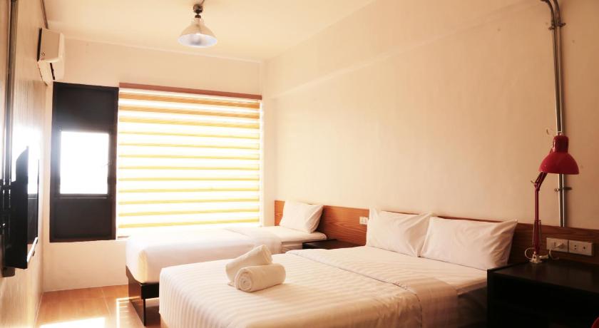 a hotel room with a bed and a lamp, Travelbee Seaside Inn in Bohol