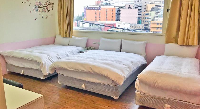 a hotel room with a bed and a window, Happy Holiday Hotel in Taoyuan