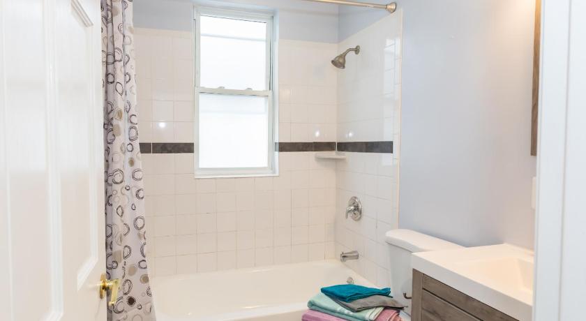 a white toilet sitting next to a bath tub in a bathroom, 3-min walk to PETWORTH METRO STATION ;10 mins to CONVENTION CENTER: PRIVATE COZY and QUIET BEDROOM a in Washington D.C.