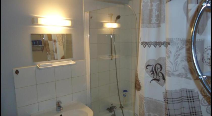 a bathroom with a toilet, sink, and mirror, studio meuble avec balcon in Arcueil