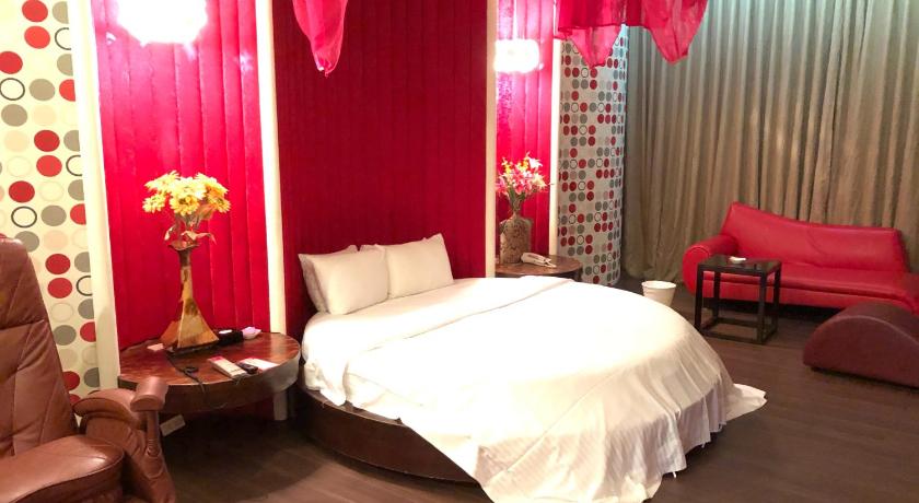 a bed room with a red bedspread and a red dresser, Idee Spa Motel in Taoyuan