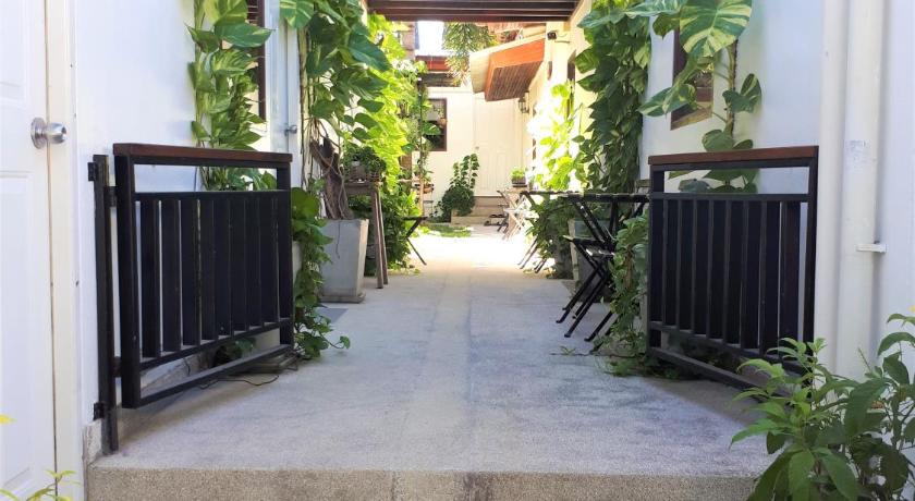 a walkway with a bunch of plants in it, The Reef Hotel in Ko Lipe