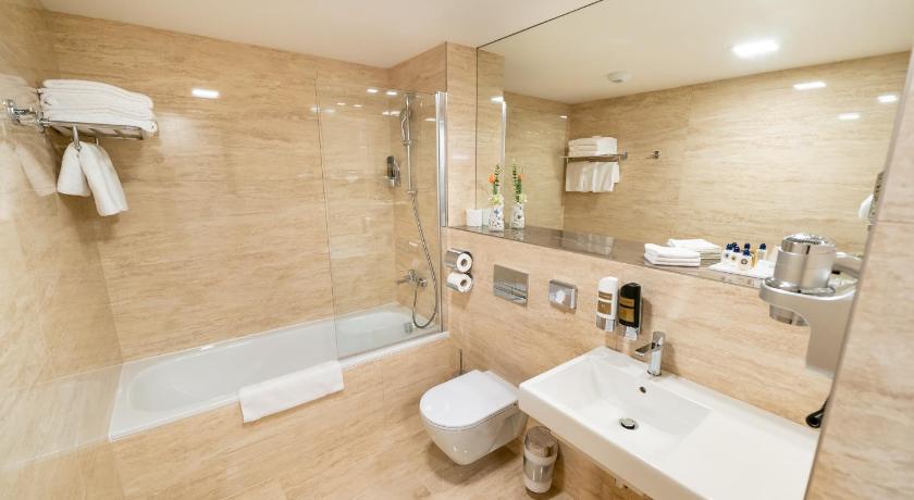 a bathroom with a sink, toilet and bathtub, Grandium Hotel Prague in Prague