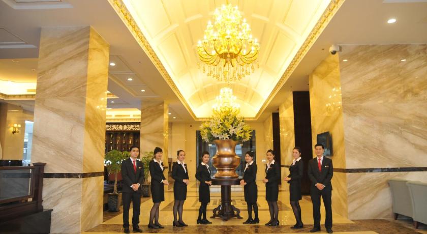 men in suits and ties standing in front of a lobby, The Mira Hotel in Bình Dương