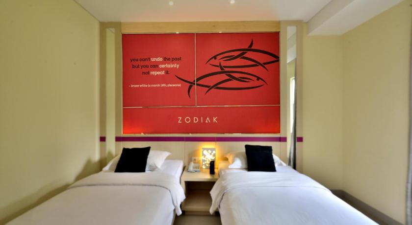 a hotel room with two beds and two lamps, Zodiak Hotel at Kebon Kawung in Bandung