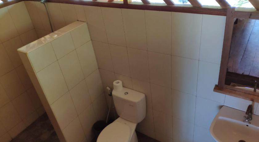 a bathroom with a toilet and a sink, Harmony Bay Dive Resort in Pulau Una Una