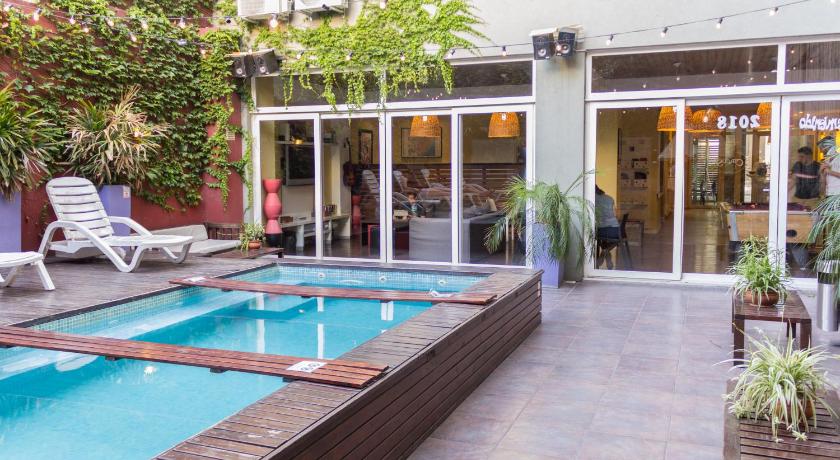a patio with a pool and a patio chair, Circus Hostel in Buenos Aires