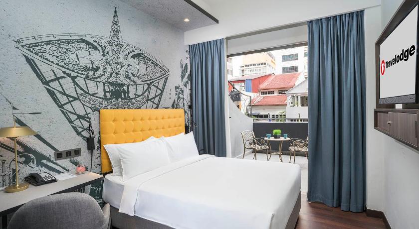 a bedroom with a large bed and a large window, Travelodge City Centre in Kuala Lumpur