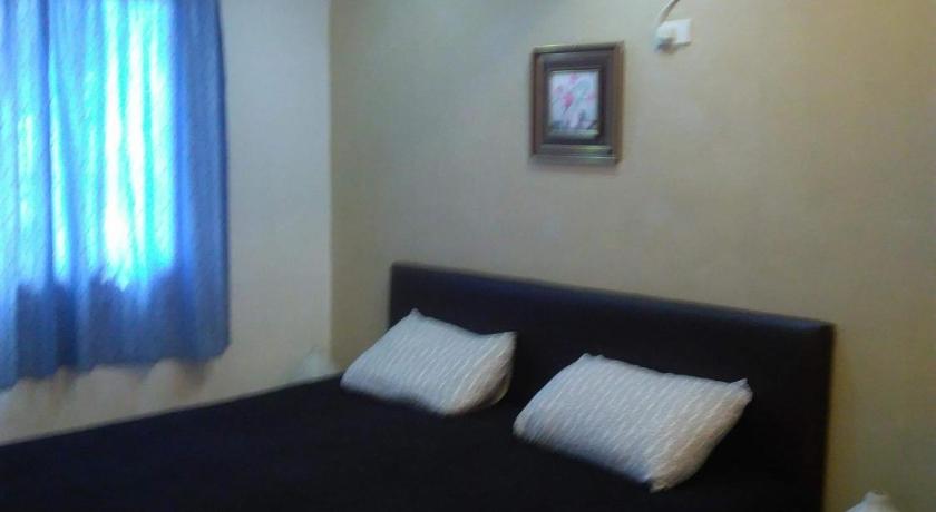 a bedroom with a bed and a lamp, Maria's house nearby Victory Town Center. in San Jose del Monte