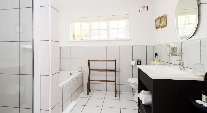 a bathroom with a sink, toilet and bathtub, Westville Bed and Breakfast in Durban