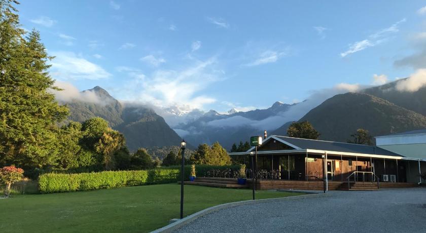 a small town with a mountain range, High Peaks Hotel in Fox Glacier