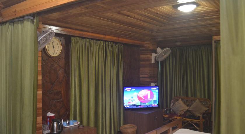 a living room filled with furniture and a tv, Quinton Enclave in Shillong