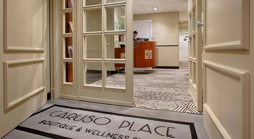 a room with a door and some books on the floor, Caruso Place Boutique & Wellness Suites in Naples
