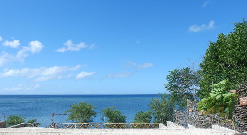 a beach with a view of the ocean, Descanso En Paraiso Resort in Siquijor Island