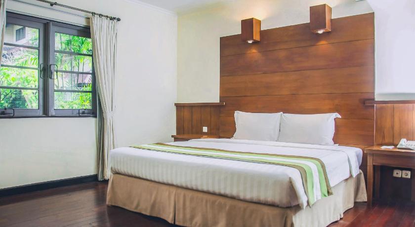 a bedroom with a bed and a desk, Whiz Residence Darmo Harapan Surabaya in Surabaya